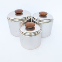 Set of 3 Rose Gold Mirro Canisters with Wood Tops and some surface wear
