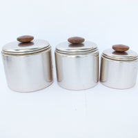 Set of 3 Rose Gold Mirro Canisters with Wood Tops and some surface wear