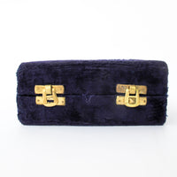 Two matching brass champagne flutes in a blue velvet box