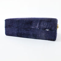 Two matching brass champagne flutes in a blue velvet box