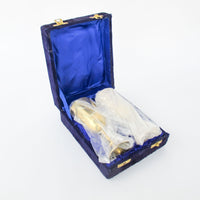 Two matching brass champagne flutes in a blue velvet box
