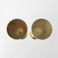 Two matching brass champagne flutes in a blue velvet box