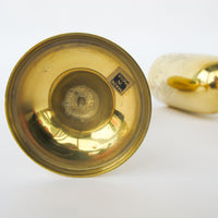 Two matching brass champagne flutes in a blue velvet box