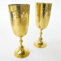 Two matching brass champagne flutes in a blue velvet box