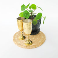 Two matching brass champagne flutes in a blue velvet box