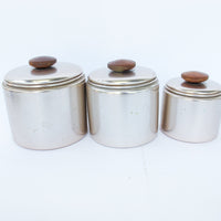 Set of 3 Rose Gold Mirro Canisters with Wood Tops and some surface wear