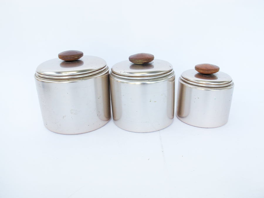 Set of 3 Rose Gold Mirro Canisters with Wood Tops and some surface wear