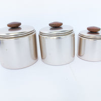 Set of 3 Rose Gold Mirro Canisters with Wood Tops and some surface wear