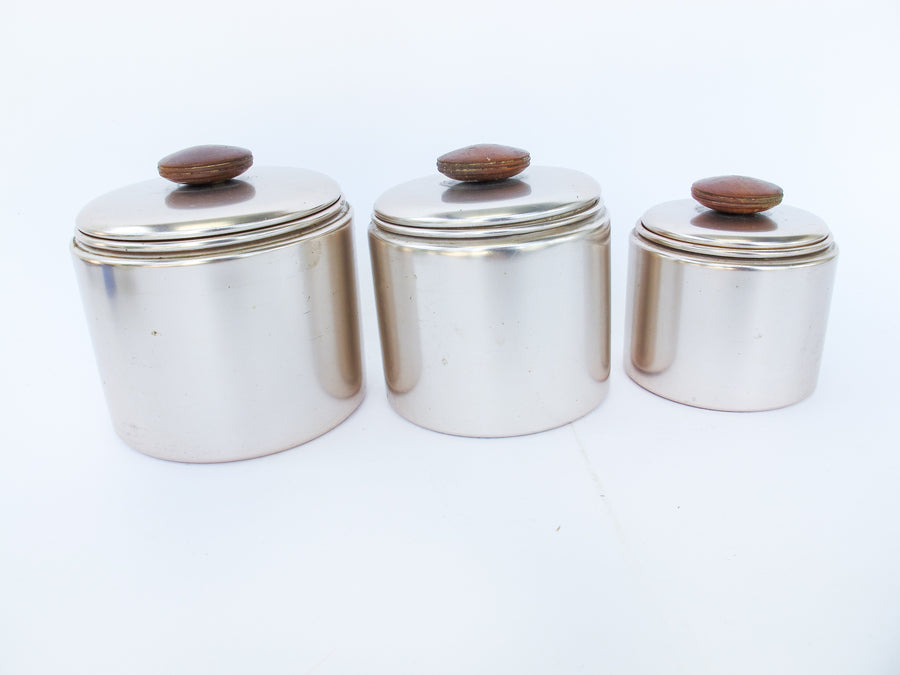 Set of 3 Rose Gold Mirro Canisters with Wood Tops and some surface wear