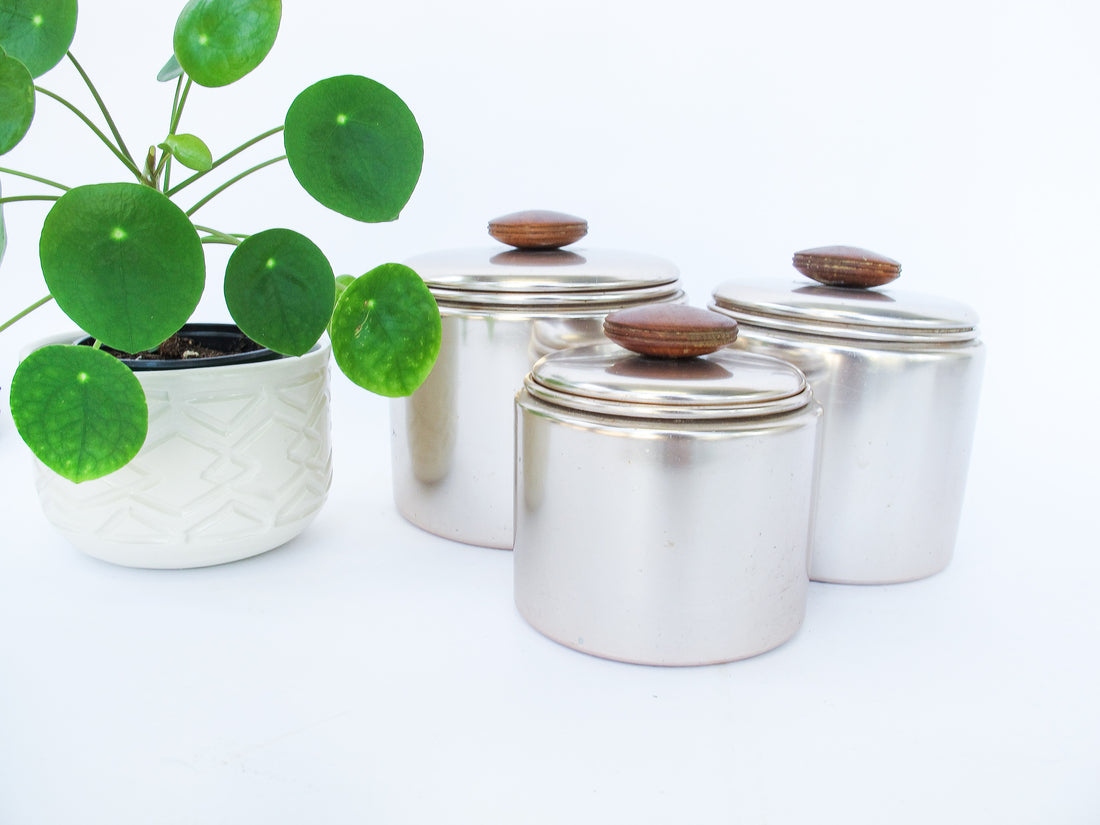 Set of 3 Rose Gold Mirro Canisters with Wood Tops and some surface wear