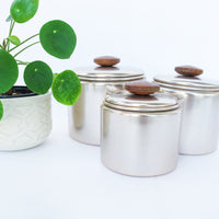 Set of 3 Rose Gold Mirro Canisters with Wood Tops and some surface wear