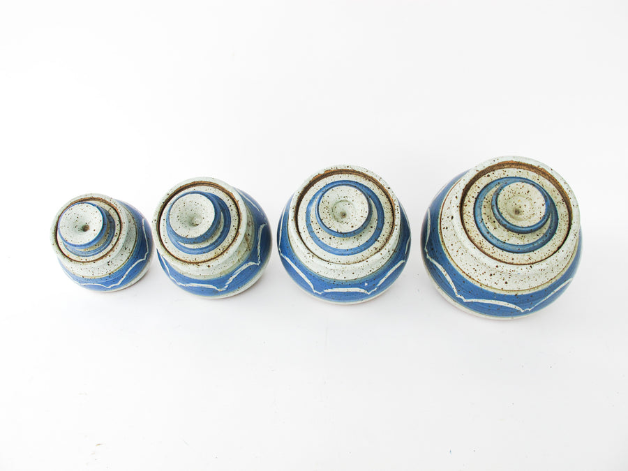 Set of 4 Hand Spun Leaning Ceramic Canisters with Button Top Lids and Blue Wave Design