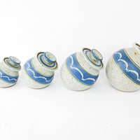 Set of 4 Hand Spun Leaning Ceramic Canisters with Button Top Lids and Blue Wave Design