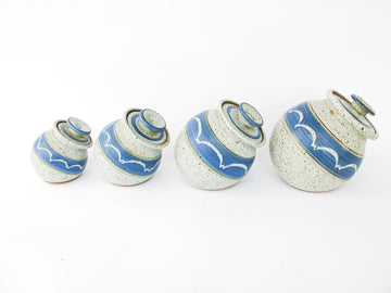 Set of 4 Hand Spun Leaning Ceramic Canisters with Button Top Lids and Blue Wave Design