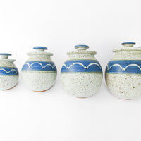 Set of 4 Hand Spun Leaning Ceramic Canisters with Button Top Lids and Blue Wave Design