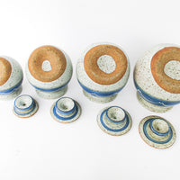 Set of 4 Hand Spun Leaning Ceramic Canisters with Button Top Lids and Blue Wave Design